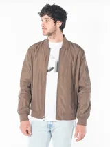 Campera bomber marrón de poliéster, con cierre frontal, puños y dobladillo acanalados, bolsillos laterales con cierre y logo CK bordado en el pecho.