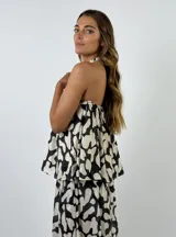 Top marrón con estampado abstracto en color crema, con cuello halter y espalda descubierta.