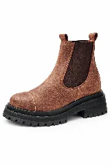 Bota tipo Chelsea de gamuza color marrón, con paneles laterales elásticos oscuros y suela track de goma negra con plataforma.