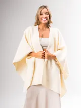 Ruana color crema confeccionada en lana italiana con textura tipo "corderito". Se puede usar abierta o cerrada.