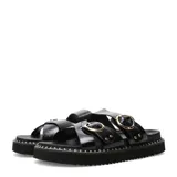 Sandalias planas Miss Carol Zelv de color negro, con diseño de tiras anchas cruzadas y hebillas metálicas doradas. Posee suela chunky con costuras visibles alrededor de la plataforma.