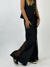 Pantalón de lino color beige con detalle de red en los laterales.