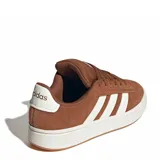Championes urbanos Adidas Grand Court Alpha, color marrón con las icónicas tres tiras laterales en color blanco. Presentan un diseño de corte bajo con capellada de gamuza, cordones al tono y suela de goma blanca con base en color caramelo.