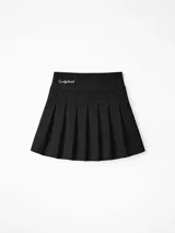 Pollera corta negra de gabardina, estilo plisado, con tiro medio y bordado frontal.