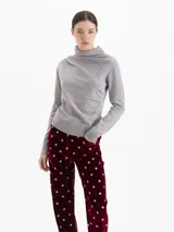 Sweater de lana merino color gris, con cuello medio alto y detalle de frunces en los hombros que aportan volumen a la prenda.