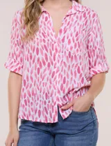Camisa de lino sintético con estampado floral en tonos azules y beige sobre fondo blanco, de corte holgado, mangas tres cuartos y cuello camisero.
