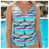 Malla enteriza estampada con diseño tropical de palmeras y ondas en tonos celestes, rosados y verdes, con tirantes cruzados en la espalda y volados sutiles en la parte inferior.