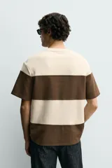 Camiseta relaxed fit color marrón, confeccionada en tejido con estructura, cuello redondo y manga corta.