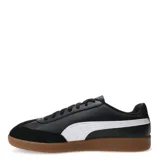 Championes urbanos Puma modelo 9T, color negro con detalles en blanco. Presentan una combinación de cuero sintético y gamuza en la puntera, con la icónica franja lateral de la marca y suela de goma color caramelo.