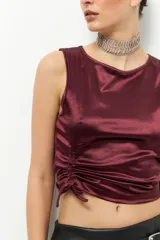 Top sin mangas de satén color gris topo, con cuello redondo y cordones laterales para fruncir.