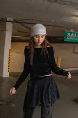 Top de terciopelo verde esmeralda con escote off-shoulder y mangas largas fruncidas.