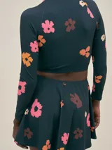 Minifalda de traje de baño azul marino con estampado de flores rosas y naranjas.