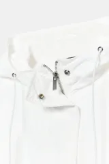 Chaqueta técnica de corte oversize en color blanco, con capucha ajustable mediante cordones, cierre frontal con cremallera y botones ocultos, mangas largas con puños elásticos y bajo asimétrico con cordón ajustable.