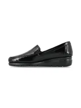 Slip-on de cuero charol negro con suela anatómica de goma y talón curvado.