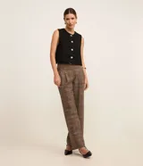 Chaleco blanco de tweed con cuello redondo, abotonado en el frente y corte entallado.