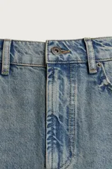 Jeans de corte recto y tiro medio confeccionados en denim de algodón con efecto lavado, diseño de cinco bolsillos y cierre frontal con cremallera y botón.