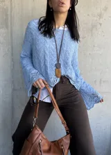 Sweater celeste de hilo con calados y mangas largas acampanadas.