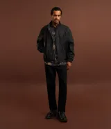 Pantalón de sastrería negro de corte recto, con trabillas, elástico trasero en la cintura, bolsillos laterales y cierre tradicional.