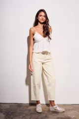 Jean de mujer color crema o blanco roto, de corte baggy y tiro medio. Confeccionado en algodón con un pequeño porcentaje de elastano.