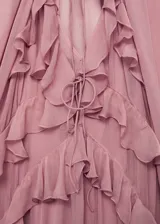 Vestido largo de gasa semitransparente en color rosado, con diseño de volantes verticales en el frente, escote en pico con cierre de lazo y mangas largas abullonadas. Incluye forro interior.