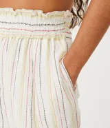 Pantalón carrot de algodón con cintura alta elástica y rayas verticales multicolores.