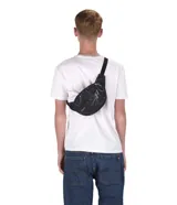 Riñonera negra de la marca JanSport, modelo Fifth Avenue, con parche frontal de la marca y cierres metálicos.