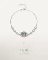 Pulsera de plata con dije central en forma de ojo turco, adornado con circonias multicolores y pavé de circonias blancas.