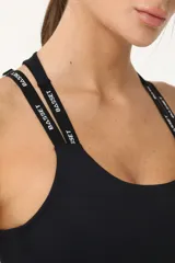 Top deportivo negro con espalda cruzada, elástico inferior y tiras regulables con logo Basset.