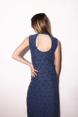 Vestido midi sin mangas de color azul con patrón geométrico texturizado. Presenta cuello mao, abertura en forma de gota en el pecho, cierre lateral con botones dorados y tajo en la falda.