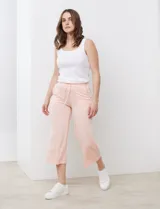 Pantalón capri color rosa claro de jersey marca Cupio, con pretina ancha elastizada, lazo de ajuste y bolsillos inclinados en la parte delantera.