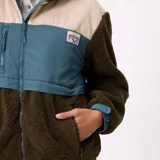 Campera Rusty de diseño color block, con cuerpo y mangas de tejido sherpa en color verde oliva, panel superior de pana en color beige y detalles en nylon azul. Cuenta con capucha, cierre frontal completo y bolsillos laterales.