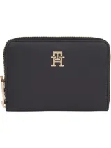 Billetera pequeña Tommy Hilfiger color negro con cierre de cremallera y logo metálico dorado en el frente.