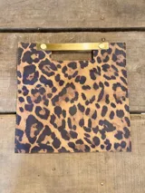 Sobre de mano con diseño cuadrado y estampado animal print de leopardo. Cuenta con una estructura rígida y una manija metálica dorada integrada en la parte superior.