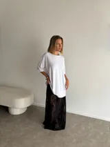 Pollera larga de encaje negro, corte recto y tiro alto.