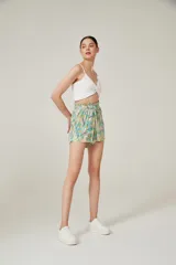 Short de viscosa con cintura elastizada y lazo ajustable. Estampado con hojas en tonos celeste, verde y amarillo sobre fondo beige.