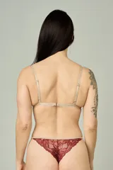 Conjunto de lencería compuesto por un bralette triangular de encaje con breteles regulables y una tanga colaless regulable con detalles de encaje y entrepierna de algodón.
