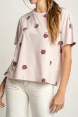 Remera rosa de algodón con estampado de lunares marrones.