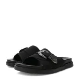 Sandalias planas Miss Carol Sage de estilo slide, color negro, con una tira ancha en el empeine decorada con una gran hebilla metálica plateada de estilo Western con grabados en relieve. Suela con ligera plataforma y base estriada.