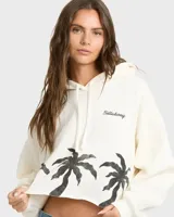 Buzo hoodie Billabong de corte cropped, color blanco, con capucha y cordón ajustable. Cuenta con estampado de palmeras negras en la parte inferior y el logo de la marca bordado en el pecho.