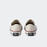 Championes Converse Chuck 70 OX color crema, de caña baja y cordones blancos.