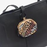 Cartera tipo tote bag de color negro con textura granulada, cuenta con doble asa de hombro y un monedero circular colgante con estampado animal print.