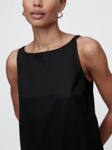 Vestido corto de lino color rojo tomate, con escote cuadrado y tirantes finos. Presenta un diseño de corte recto y holgado.