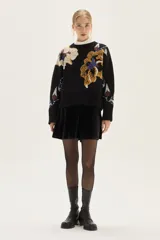 Sweater de cuello redondo con diseño de jacquard floral en cuerpo y mangas, confeccionado en tejido de punto con terminaciones acanaladas en puños y ruedo.