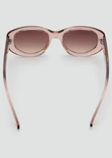 Lentes de sol con montura de pasta en color rosado translúcido y diseño ovalado. Lentes con protección UV y acabado degradado.
