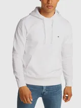 Buzo blanco de felpa de algodón con capucha ajustable con cordón, bolsillo tipo canguro, puños y bajo de punto canalé, y logo de Tommy Hilfiger bordado en el pecho.