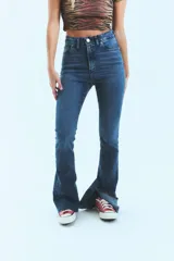 Pantalón de jean azul de tiro alto, corte semi oxford con botamanga ancha y abierta, y ruedo al corte.