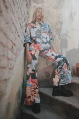 Pantalón palazzo de crepe de seda estampado con motivos florales en tonos fucsia, rojo y blanco. Tiene cierre invisible lateral y costura francesa.