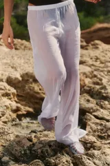 Pantalón de gasa brillante color blanco, con elástico en la cintura y calce relajado.