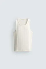 Camiseta sin mangas (tank top) de corte relajado (relaxed fit) con cuello redondo y sisa, confeccionada en tejido con algodón.