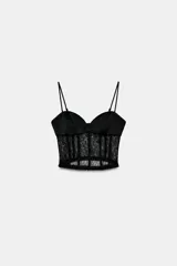 Top estilo corset con copas de tejido satinado y cuerpo de encaje semitransparente con varillas. Presenta tirantes finos ajustables y cierre lateral con cremallera oculta.